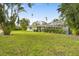 Large backyard with a screened pool and lush landscaping at 4810 Bay Shore Rd, Sarasota, FL 34234