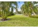 Spacious backyard with lush landscaping and a white picket fence at 4810 Bay Shore Rd, Sarasota, FL 34234