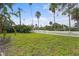 Spacious backyard with lush landscaping and a white picket fence at 4810 Bay Shore Rd, Sarasota, FL 34234