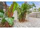 Spacious backyard with lush landscaping and a large screened patio at 4810 Bay Shore Rd, Sarasota, FL 34234