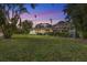 Large grassy backyard with screened pool area at 4810 Bay Shore Rd, Sarasota, FL 34234