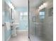 Bathroom with pedestal sink, light blue walls and shower at 4810 Bay Shore Rd, Sarasota, FL 34234