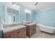 Elegant bathroom featuring double vanity and freestanding tub at 4810 Bay Shore Rd, Sarasota, FL 34234