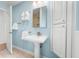 Clean bathroom with pedestal sink, linen closet and shower at 4810 Bay Shore Rd, Sarasota, FL 34234