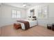 Spacious bedroom with light wood floors and plantation shutters at 4810 Bay Shore Rd, Sarasota, FL 34234
