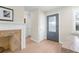 Light and bright entryway with fireplace and hardwood floors at 4810 Bay Shore Rd, Sarasota, FL 34234