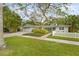 Charming single story home with mature landscaping and a white picket fence at 4810 Bay Shore Rd, Sarasota, FL 34234