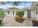 Front entrance with gray door and brick walkway at 4810 Bay Shore Rd, Sarasota, FL 34234