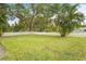 Large grassy front yard with a white picket fence at 4810 Bay Shore Rd, Sarasota, FL 34234