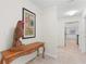 Hallway features decorative console table and view into kitchen at 4810 Bay Shore Rd, Sarasota, FL 34234
