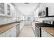Modern kitchen with white cabinets, granite countertops and stainless steel appliances at 4810 Bay Shore Rd, Sarasota, FL 34234