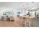 Open kitchen with island, light cabinets, and hardwood floors at 4810 Bay Shore Rd, Sarasota, FL 34234