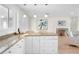 Kitchen island with granite countertop and seating for casual dining at 4810 Bay Shore Rd, Sarasota, FL 34234