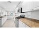 Modern kitchen with white cabinets, granite countertops and stainless steel appliances at 4810 Bay Shore Rd, Sarasota, FL 34234