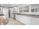 Modern kitchen with white cabinets, granite countertops and stainless steel appliances at 4810 Bay Shore Rd, Sarasota, FL 34234