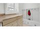 Laundry room with built-in cubbies and shaker cabinets at 4810 Bay Shore Rd, Sarasota, FL 34234