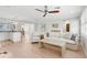Living room with light hardwood floors and white couch at 4810 Bay Shore Rd, Sarasota, FL 34234