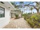 Large flagstone patio bordered by lush landscaping at 4810 Bay Shore Rd, Sarasota, FL 34234