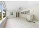 Spacious screened patio with tile flooring, ceiling fan and built-in bar at 4810 Bay Shore Rd, Sarasota, FL 34234