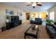 Living room with leather sofas, a large TV, and view into the kitchen at 4914 60Th E Dr, Bradenton, FL 34203