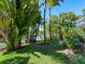 Landscaped backyard with tropical plants and canal view at 5140 Windward Ave, Sarasota, FL 34242