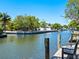 Peaceful canal view with lush landscaping and a dock at 5140 Windward Ave, Sarasota, FL 34242