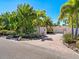 House exterior featuring a brick driveway, lush landscaping, and gated entry at 5140 Windward Ave, Sarasota, FL 34242