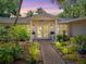 Inviting home exterior featuring a walkway, lush landscaping, and double front doors at 5140 Windward Ave, Sarasota, FL 34242