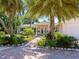 Attractive home exterior with a brick walkway, palm trees, and well-maintained landscaping at 5140 Windward Ave, Sarasota, FL 34242