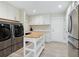 Laundry room with modern appliances and ample storage at 5140 Windward Ave, Sarasota, FL 34242