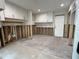 Laundry room with white cabinets and a concrete floor, undergoing renovation at 5140 Windward Ave, Sarasota, FL 34242