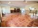 Large living room with terracotta tile floors and open floor plan, undergoing renovation at 5140 Windward Ave, Sarasota, FL 34242