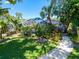Screened-in pool area surrounded by tropical landscaping at 5140 Windward Ave, Sarasota, FL 34242