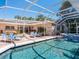 Inviting pool and spa with covered patio and lounge chairs at 5140 Windward Ave, Sarasota, FL 34242