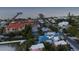 Aerial view showing a two story house with blue roof and private pool near the ocean at 518 Spring Ave, Anna Maria, FL 34216