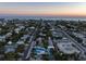 Aerial view highlighting a modern two-story house and a refreshing pool in a coastal setting at 518 Spring Ave, Anna Maria, FL 34216