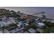 Aerial view showcasing a two-story house near the waterfront with a pier visible at 518 Spring Ave, Anna Maria, FL 34216