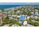 Aerial view of a two-story house near the beach with a pool at 518 Spring Ave, Anna Maria, FL 34216