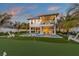 Two-story home with private pool, putting green, and lush landscaping at 518 Spring Ave, Anna Maria, FL 34216