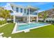 Two story home with private pool, putting green, and tropical landscaping at 518 Spring Ave, Anna Maria, FL 34216