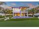 Two-story home with private pool, putting green, and lush landscaping at 518 Spring Ave, Anna Maria, FL 34216