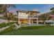 Two-story home with private pool, putting green, and lush landscaping at 518 Spring Ave, Anna Maria, FL 34216