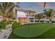 Two-story home with private pool, putting green, and lush landscaping at 518 Spring Ave, Anna Maria, FL 34216