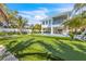 Large backyard with putting green, pool and a two-story home at 518 Spring Ave, Anna Maria, FL 34216