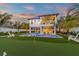 Two-story home with private pool, putting green, and lush landscaping at 518 Spring Ave, Anna Maria, FL 34216