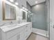 Double vanity bathroom with a walk-in shower at 518 Spring Ave, Anna Maria, FL 34216