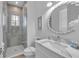Modern bathroom with a walk-in shower and double vanity at 518 Spring Ave, Anna Maria, FL 34216