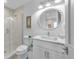 Clean bathroom with white vanity, walk-in shower, and modern toilet at 518 Spring Ave, Anna Maria, FL 34216