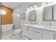 Elegant bathroom with double vanity, soaking tub, and walk-in shower at 518 Spring Ave, Anna Maria, FL 34216