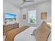 Bright bedroom with a comfy bed, dresser, and large TV at 518 Spring Ave, Anna Maria, FL 34216